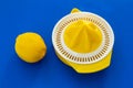 High angle view of lemon and yellow plastic hand citrus juicer Royalty Free Stock Photo