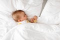 High-angle view of little baby girl sleeping on side, lying in bed under white blunket, free space Royalty Free Stock Photo
