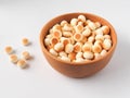 High angle view of little ball cookies on wooden bowl isolated on white background.