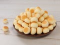 High angle view of little ball cookies on wooden plate isolated on wooden background.