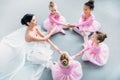 high angle view of little ballerinas and ballet teacher exercising together