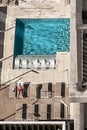 High Angle View Of Lone Man Laying Out By Pool
