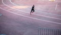 Top view Athlete running on running track. Runner sprinting on red running track in stadium Royalty Free Stock Photo