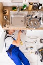 Male Plumber In Overall Fixing Sink Pipe Royalty Free Stock Photo