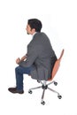 High angle view of a man with blazer sitting ,rear view, on white background Royalty Free Stock Photo