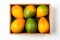 High angle view of mango fruits on a rustic wooden box isolated on white background Royalty Free Stock Photo