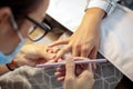 High angle view of manicurist filing fingernails