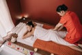 Angle view of masseur doing foot massage to woman in spa salon Royalty Free Stock Photo
