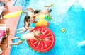 High angle view of millenial friends jumping at swimming pool party - Youth vacation concept with happy guys and girls having fun Royalty Free Stock Photo