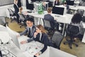 High angle view of multiracial businesspeople working with documents and desktop computers