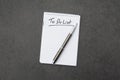 High angle view of a notepad with the to do list and a pen on grey desk Royalty Free Stock Photo