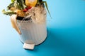 High angle view of organic waste in white compost bin by copy space on blue background Royalty Free Stock Photo