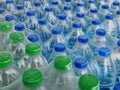 Packs of Bottled Drinking Water with Blue and Green Caps