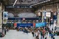 High angle view of people walking inside Victoria train station, London, UK. Selective focus, motion blur Royalty Free Stock Photo