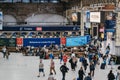 High angle view of people walking inside Victoria train station, London, UK. Selective focus, motion blur Royalty Free Stock Photo