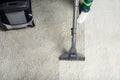 high angle view of person cleaning white carpet with professional vacuum