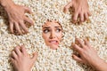 High angle view photo of funky terrified girl biting lip look zombie people arms face inside popcorn background