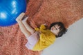High angle view photo of lovely attractive little girl lying down on carpet sleeping resting and blowing electric fan enjoying Royalty Free Stock Photo
