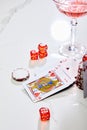 High angle view of playing cards, dice and casino chips near glass of cocktail on white background Royalty Free Stock Photo