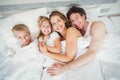 High angle view portrait of happy family relaxing on bed Royalty Free Stock Photo