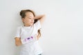 High-angle view of positive sweet little girl with broken hand wrapped in plaster bandage with colorful draw lying on Royalty Free Stock Photo