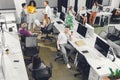 High angle view of professional young businesspeople working with papers and computers