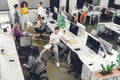 High angle view of professional young colleagues working with papers and computers