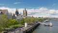Quay along river Rhine with towers of the Cathedral and great Saint martin church and medieval housesin Cologne,