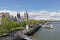 Quay along river Rhine with towers of the Cathedral and great Saint martin church and medieval housesin Cologne,