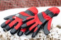High angle view of red pair of winter ski gloves on snow