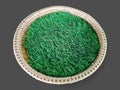 Round Woven Basket with Green Grass Isolated on Gray Royalty Free Stock Photo