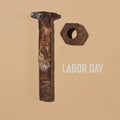 Rusty nut and bolt and text labor day