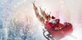 Composite image of high angle view of santa claus riding on sled with gift box Royalty Free Stock Photo