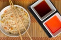 High angle view of sauces and a bowl of cooked rice with vegetables on the table Royalty Free Stock Photo