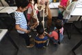 High angle view of schoolkids learning anatomy of human skeleton in classroom