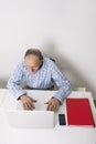 High angle view of senior businessman using laptop at office desk Royalty Free Stock Photo