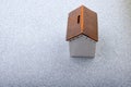 High angle view of a small house-shaped money box on the table Royalty Free Stock Photo