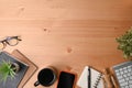 Smart phone, notebook, glasses and coffee cup on wooden desk. Royalty Free Stock Photo