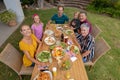 High angle view of smiling caucasian three generation family having celebration meal in garden Royalty Free Stock Photo