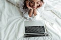 Angle view of smiling woman looking at laptop at morning