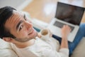 High angle view of smiling young man using his laptop Royalty Free Stock Photo