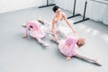 high angle view of smiling young teacher with cute little ballerinas exercising Royalty Free Stock Photo