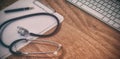 High angle view of stethoscope with clipboard by wireless keyboard and mouse