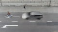 High angle view of street with cyclist and a car in blurred motion