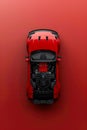 High Angle View of a Striking Red Sports Car with Hood Open, Displaying Engine Details on a Solid Red Background Royalty Free Stock Photo