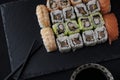 High angle view of a sushi platter with chopsticks and soy sauce on a black table Royalty Free Stock Photo