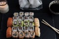 High angle view of a sushi platter with chopsticks and soy sauce on a black table Royalty Free Stock Photo