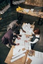 high angle view of team of architects working with architectural plans