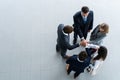 High angle view of a team of united coworkers standing with their hands together in a huddle in the modern office Royalty Free Stock Photo