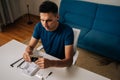 High-angle view of technician male assembling wi-fi module using tools at home office desk, focusing on intricate Royalty Free Stock Photo